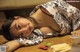 A woman laying on a table next to a plate of food.