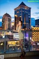 A woman in a short dress standing on a balcony.