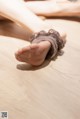 A close up of a woman's feet on a wooden floor.