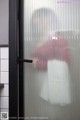 A person standing in front of a glass door.