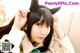 A woman with long black hair wearing a cat ears headband.