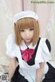 A woman in a maid outfit is posing for a picture.