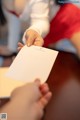 A person holding a piece of paper in their hand.