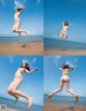 A woman in a white bikini jumping in the air on a beach.