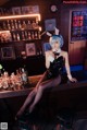 A woman sitting at a bar in a bunny costume.