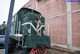 A naked woman standing on the side of a train.