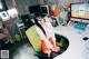 A woman sitting at a desk in front of a computer.