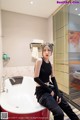 A woman sitting in a bathtub in a bathroom.