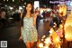 A woman standing in front of a bunch of lights.