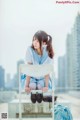 A woman sitting on top of a white chair.