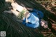 A woman laying on the ground in a blue shirt.