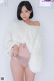 A woman in a white fuzzy jacket posing for a picture.