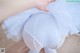 A close up of a person wearing a white tutu.