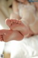 A close up of a baby's feet on a bed.