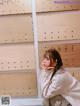 A woman standing in front of a wall of wooden signs.