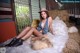 A woman sitting on top of a pile of hay.