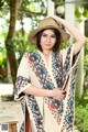 A woman wearing a straw hat and a colorful shawl.