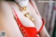 A close up of a woman wearing a red bra and a necklace.