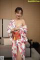 A woman in a kimono is posing for the camera.