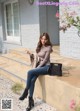 A woman sitting on the steps of a building.