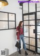 a woman standing in front of a glass door