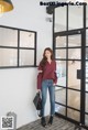 a woman standing in front of a glass door