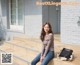 A woman sitting on the steps of a building.