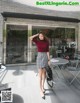 A woman standing in front of a coffee shop wearing a skirt.