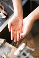 A person washing their hands in a sink.