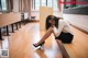 A woman sitting on the floor in a classroom.