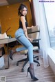 A woman sitting on a chair in a room.