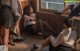 A group of young women sitting on the floor in front of a window.