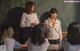 A group of young women standing in front of a blackboard.