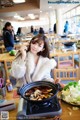 A woman sitting at a table with a bowl of food.