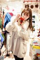 A woman in a white coat holding a stuffed animal.