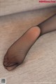 A close up of a woman's feet in black stockings.