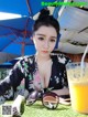 A woman sitting at a table with a glass of orange juice.