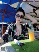 A woman sitting at a table with a glass of orange juice.